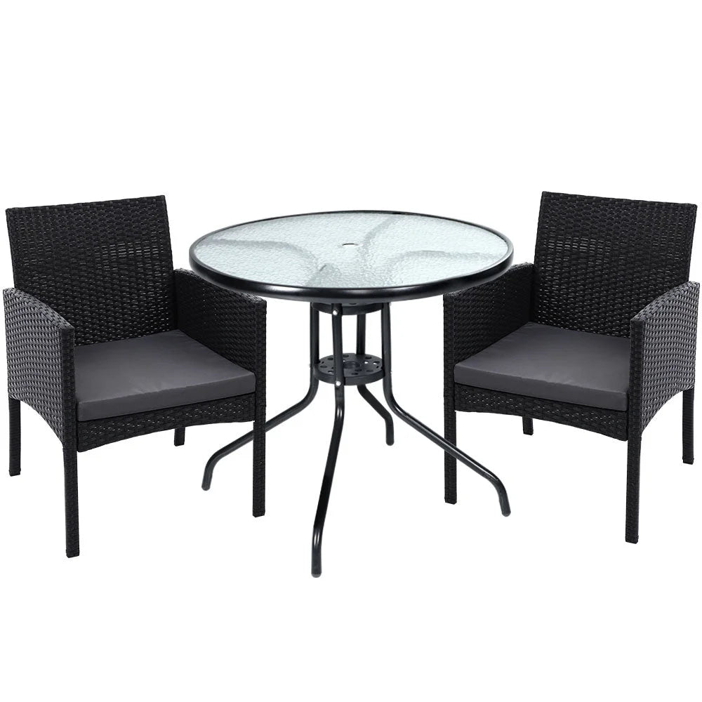 Wicker outdoor patio set with rattan armchairs and round coffee table