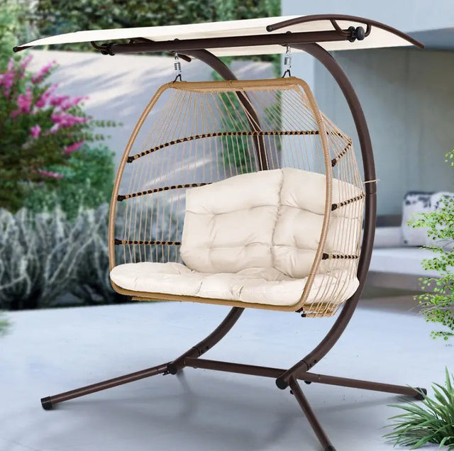 Two-seat wicker-style hanging swing with an overhead canopy