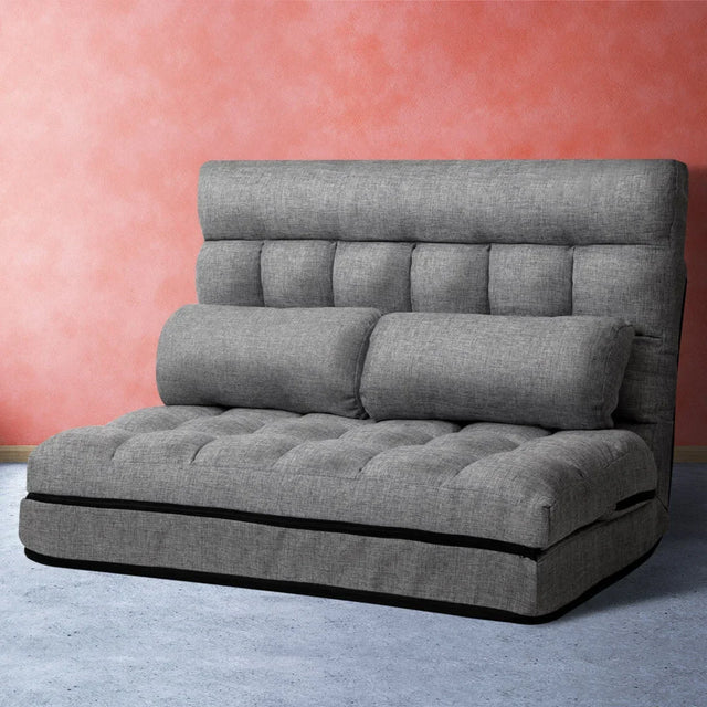 Grey upholstered sofa bed in its seated position