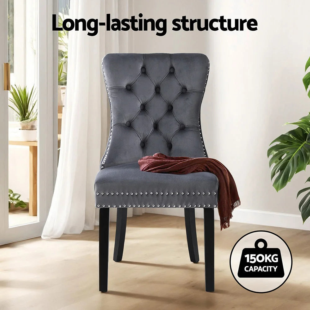 Grey velvet dining chair set with cushioned seat and curved backrest