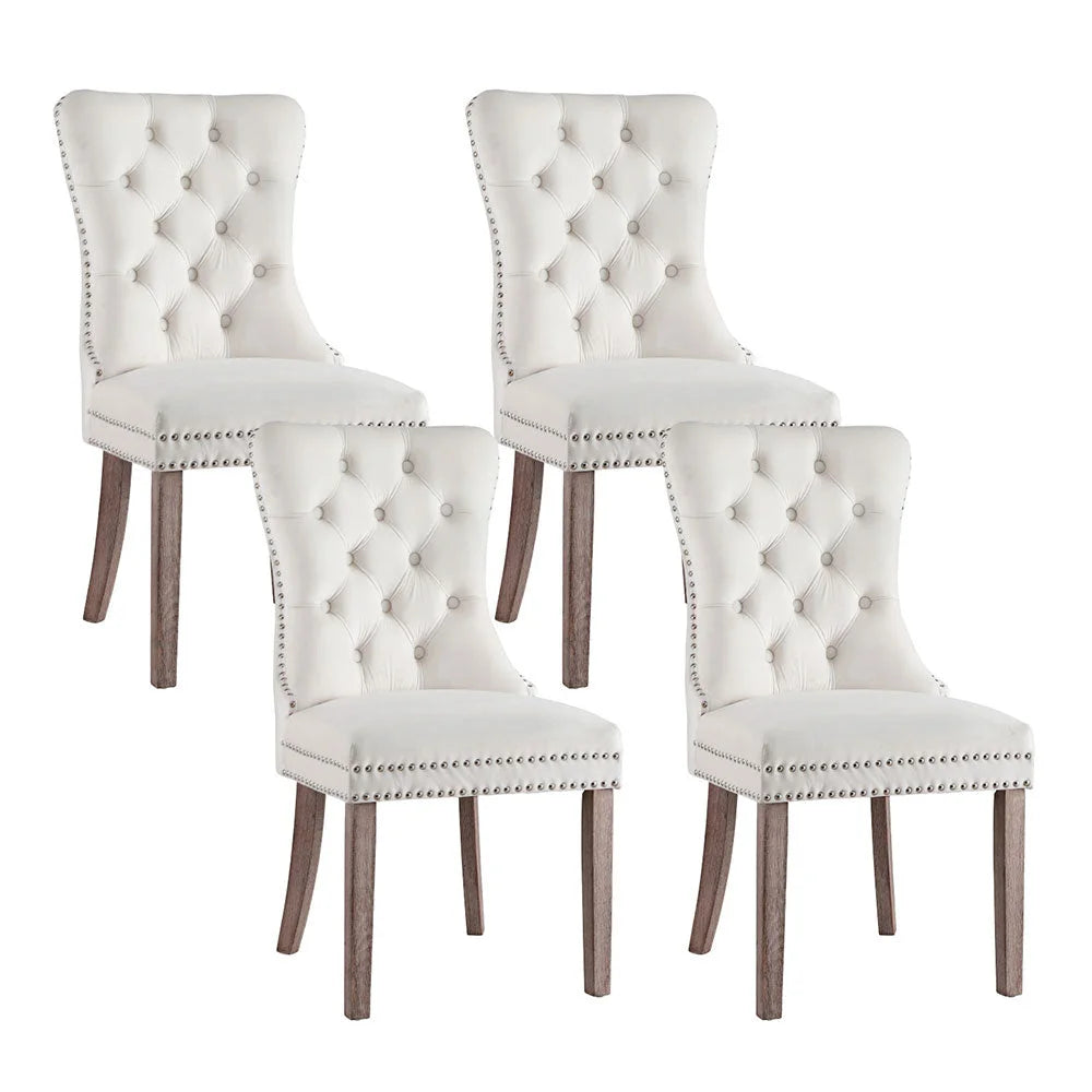 Set of four beige velvet dining chairs