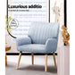 Grey fabric accent chair with armrests and tapered chair legs
