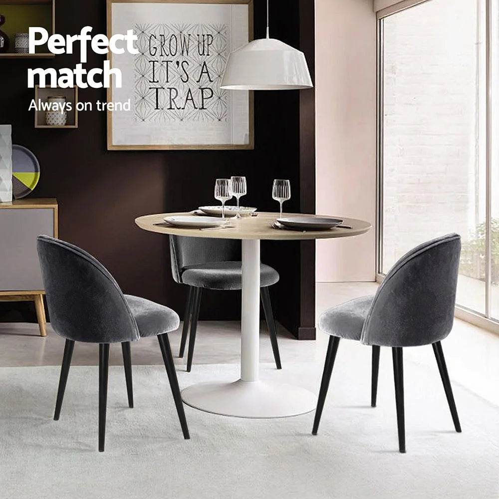 Set of four grey velvet dining chairs
