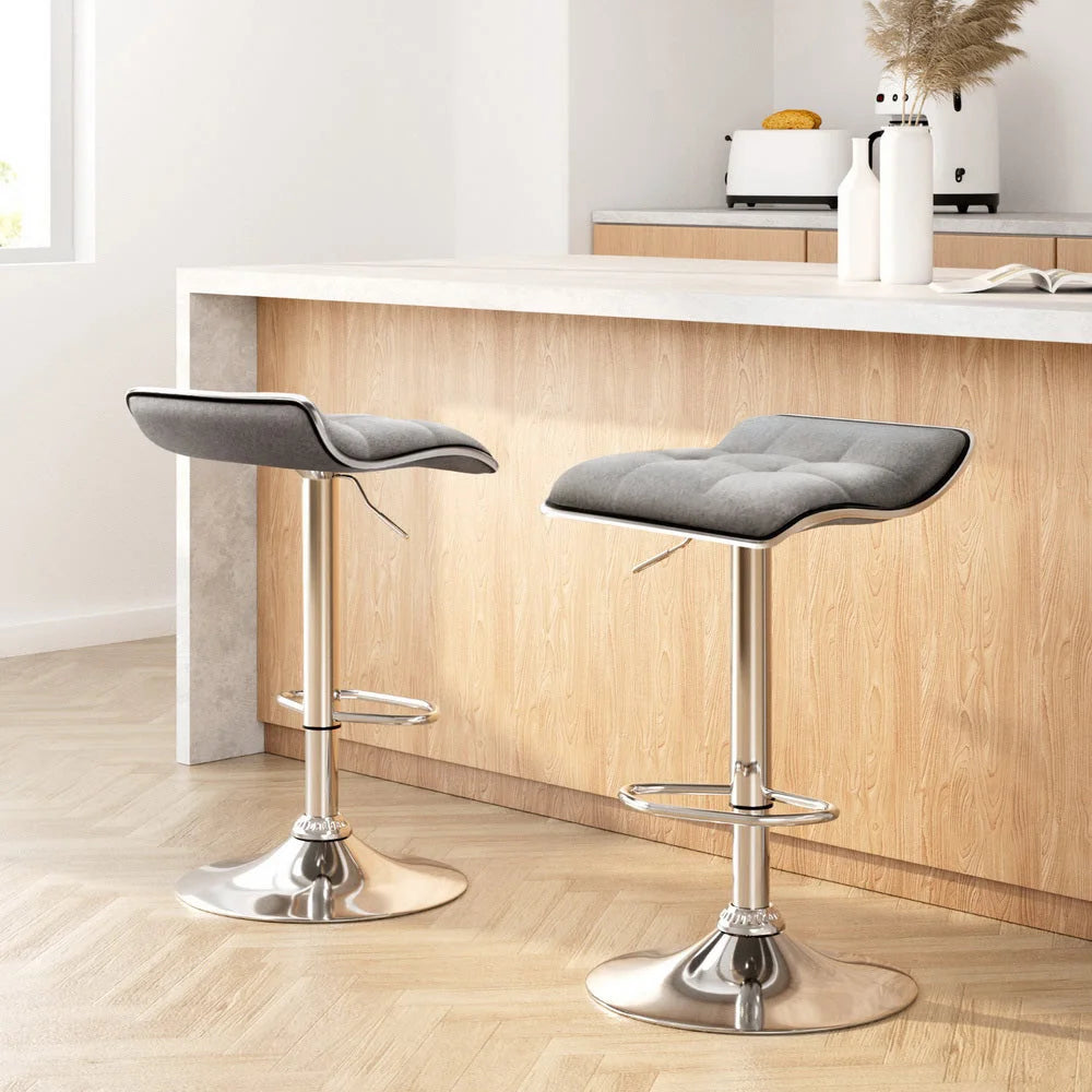 Set of two grey fabric swivel bar stools