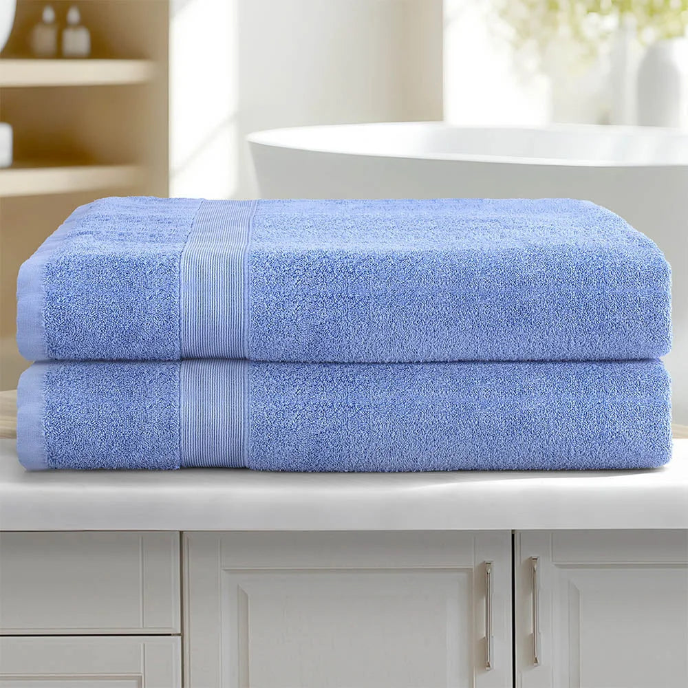 Blue cotton bath towel set with folded cotton towels and bound edges