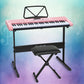 Pink piano keyboard with white keys and black top control panel