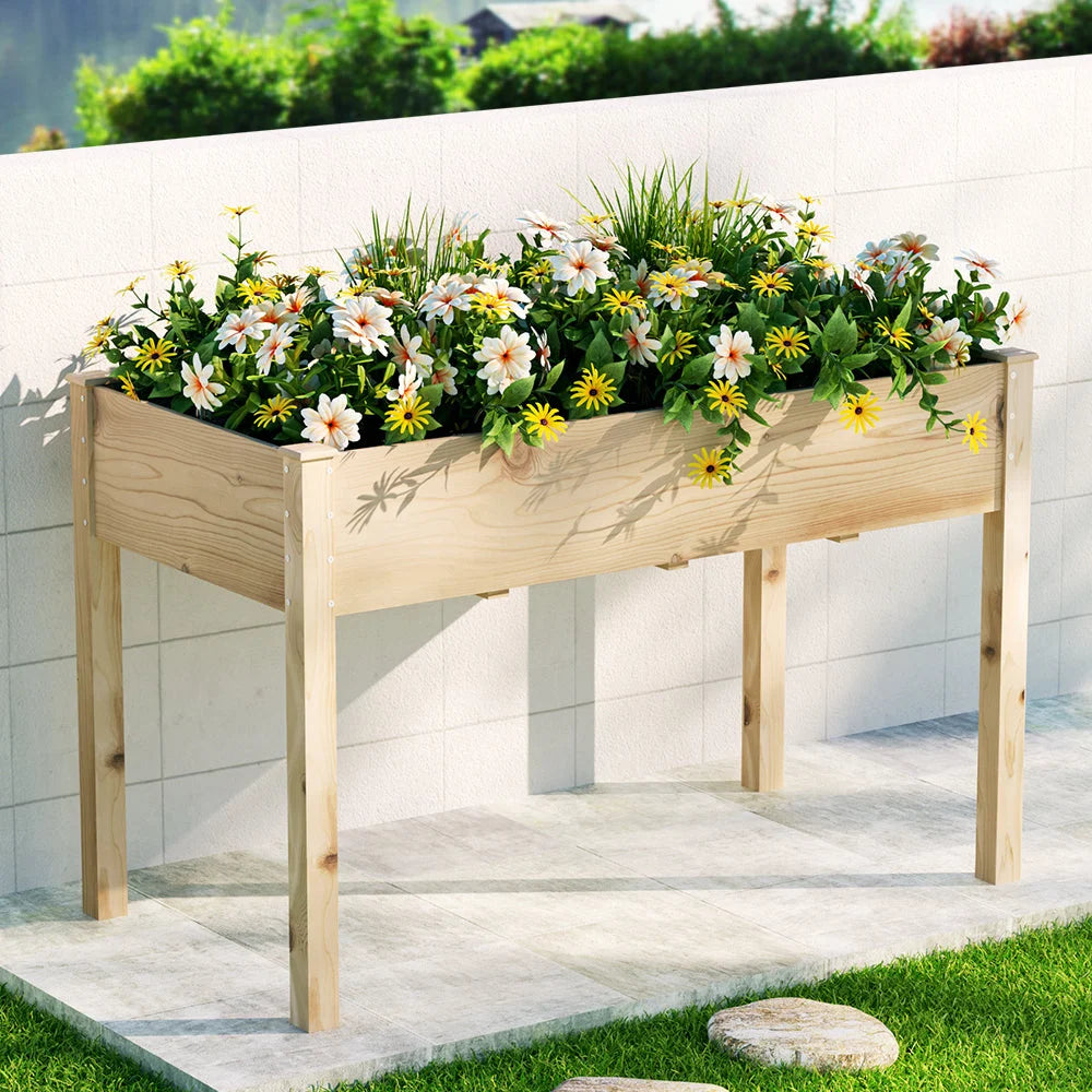 Wooden raised garden bed with green metal sides and garden soil space
