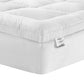 Foam mattress topper with rolled foam edge and fabric casing