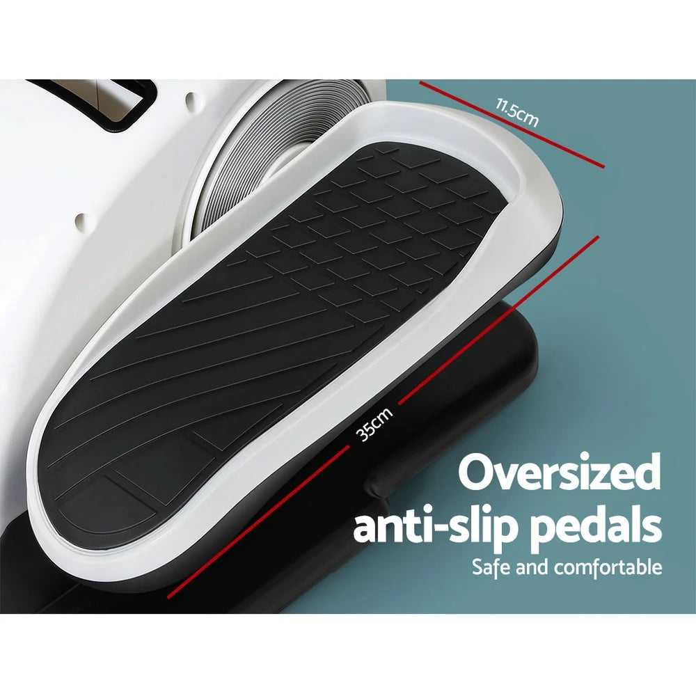 White exercise bike with portable pedal trainer and black foot straps