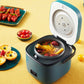 Blue mini rice cooker with its lid open and soup in the inner pot, on a yellow tabletop