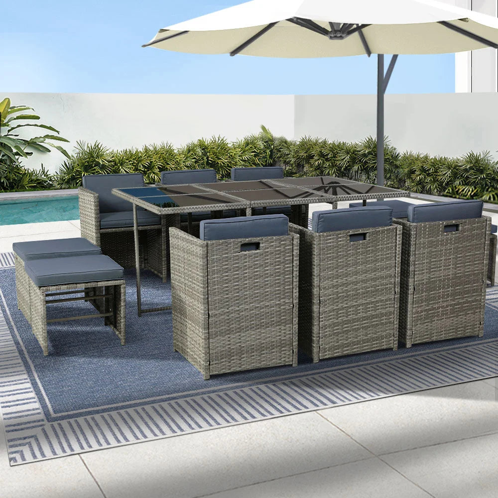 Grey wicker dining table with outdoor chairs setting patio