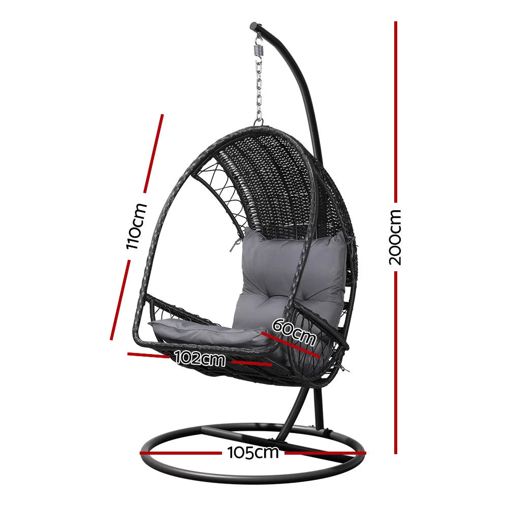 Black wicker swing chair with armrests and tapered chair legs