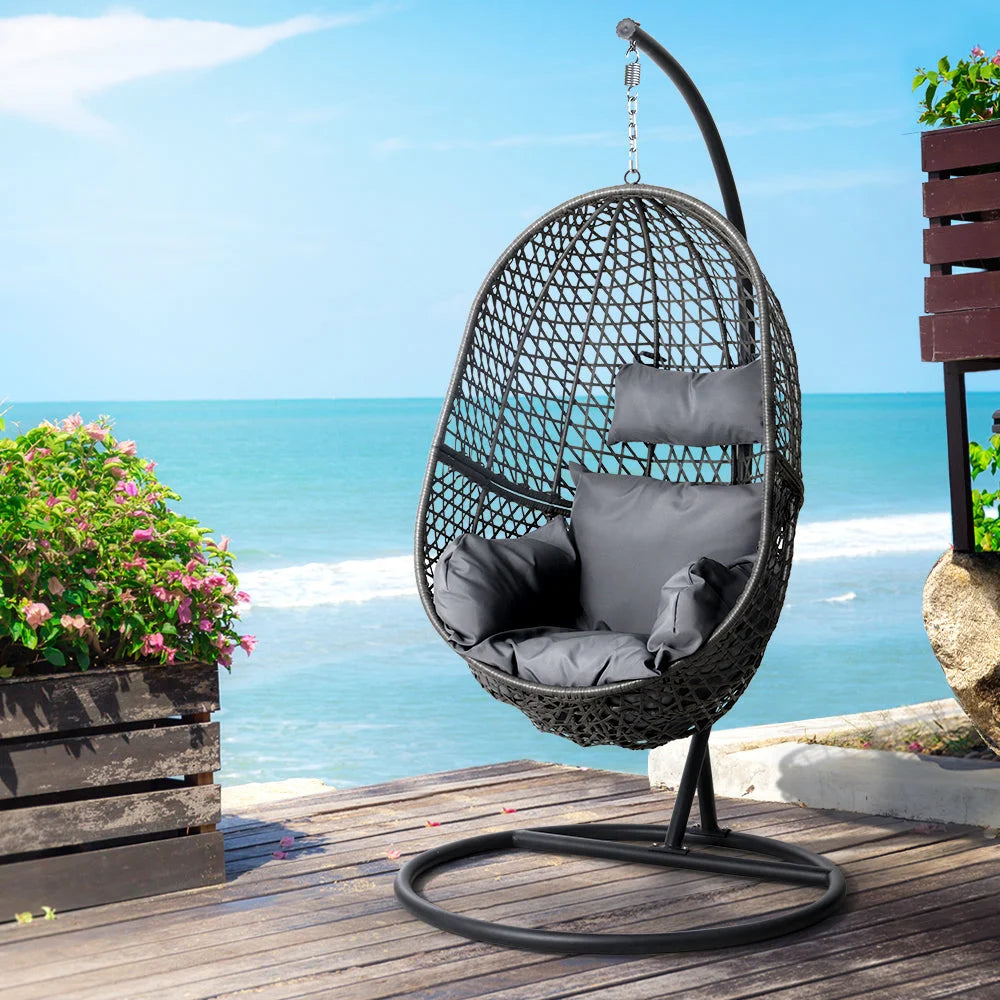 Black wicker swing chair with padded seat and sturdy metal frame