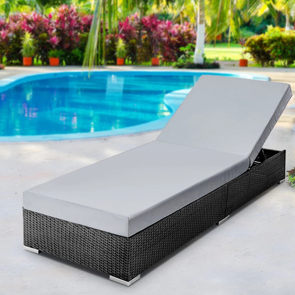 Black wicker outdoor sun lounge with component details and storage context