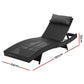 Black wicker outdoor sun lounge with reclining wooden chair and small side table