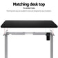 Grey standing desk with workstation surface and side shelves