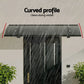 Grey metal window door awning with caster wheels and side handle rail